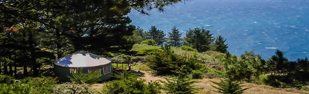 yurt among trees overlooking water